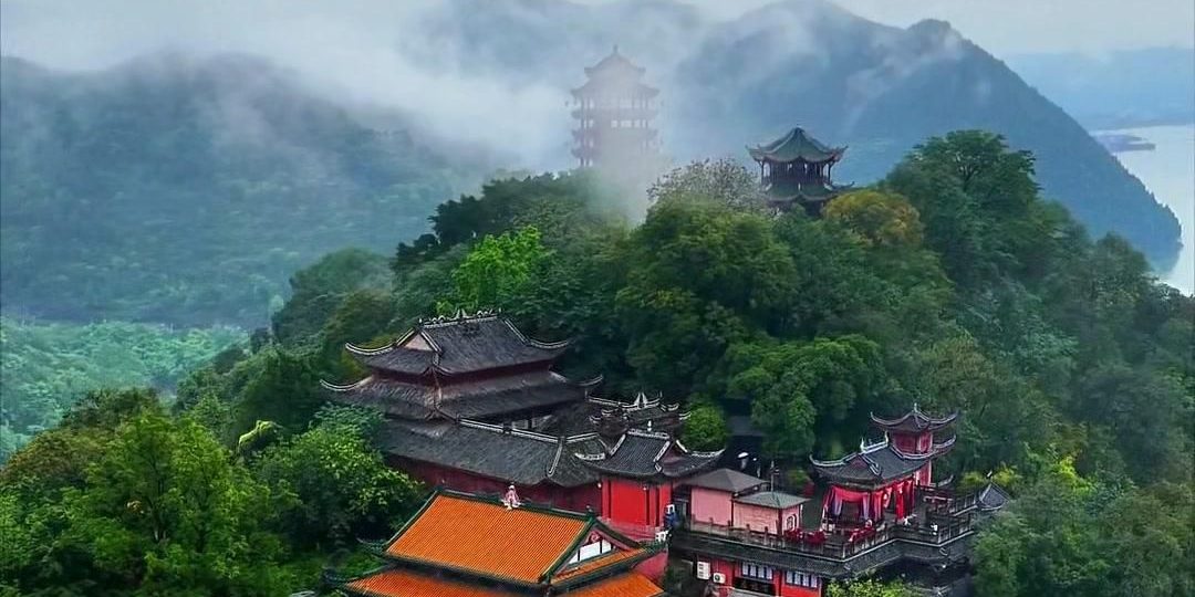 Temple halls on Mingshan hill at Fengdu Ghost City, with the Yangtze and misty hills behind