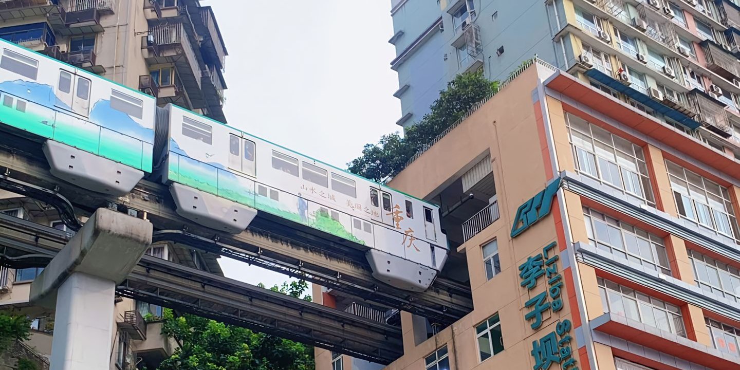Chongqing monorail train passing through the Liziba station residential building
