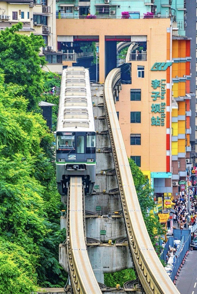 Liziba light-rail train passing through a residential tower in Chongqing