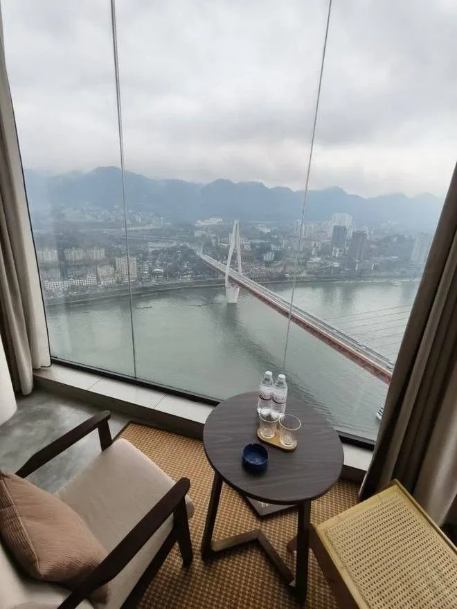 River-view hotel room overlooking a Chongqing bridge
