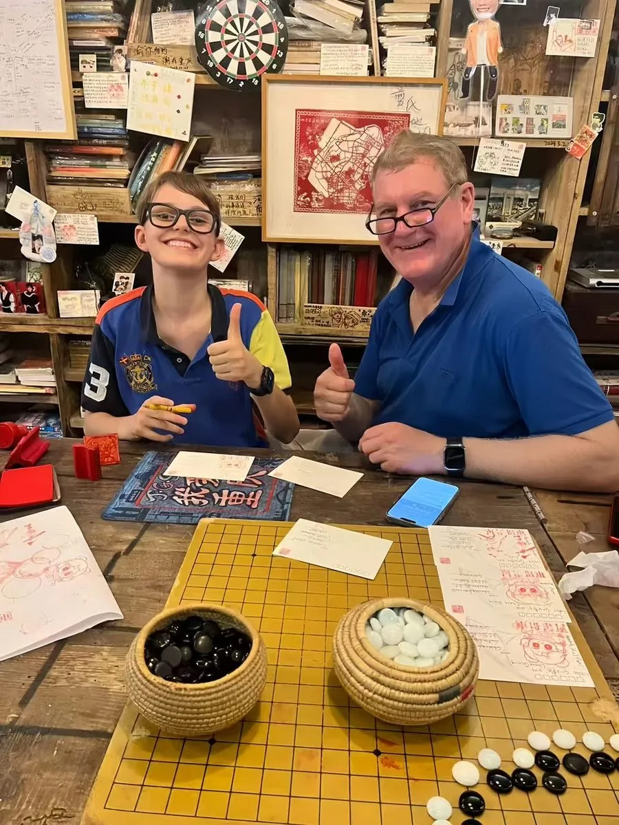 An Anjia guest trying traditional seal carving in old-town Chongqing